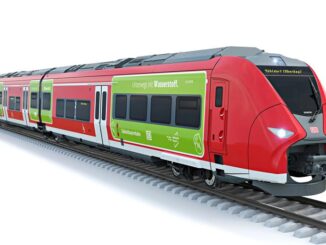 a red and green train on tracks
